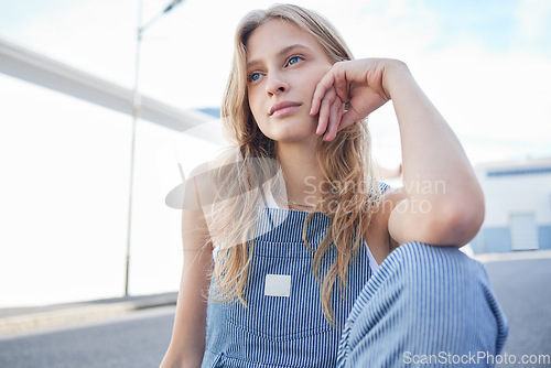 Image of Woman, street and thinking of goal, dream or future with focus, idea and wonder on face in city. Student, creative or fashion for girl sitting in road for thought, sad and depression in her life