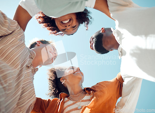 Image of Huddle, happy and friends with support, love and smile in summer against blue sky. Diversity in group of people in solidarity, trust and happiness with hug, comedy and faith in circle from below