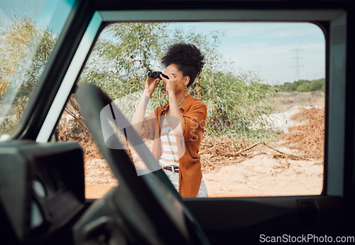 Image of Black woman with binocular for view, travel and adventure on road trip in countryside desert. Transportation for safari, outdoor journey in nature and young person with traveling lifestyle.