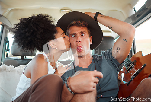 Image of Couple, car and road trip with funny face, together and kiss on travel, vacation or holiday together on the road. Woman, man and comic time with love, happiness and joke in transport in Houston
