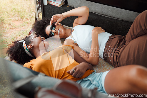 Image of Women, camper and happy lying down on road trip, travel or vacation together in summer, holiday or break. Black woman, friends and smile at funny, crazy or comic time while relax in transport to rest