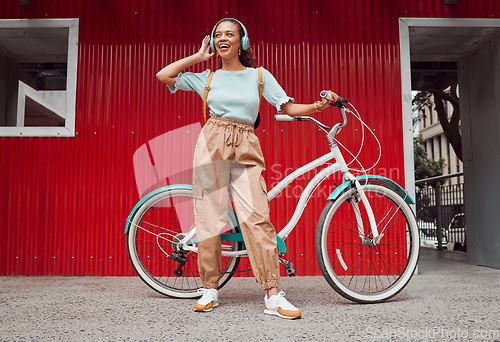 Image of Student, girl and bike with headphone music for sustainable commute leisure in Chicago, USA. Gen Z college girl with vintage bicycle enjoying eco travel in city with streaming entertainment.