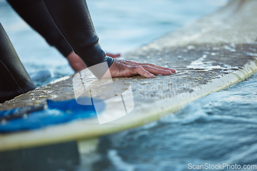 Image of Surf, ocean surfing and hand of man on surfboard in sea water. Summer water sport fitness, male healthy lifestyle and outdoor wellness exercise and relax beach travel vacation in Hawaii