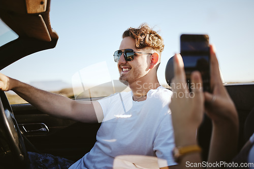 Image of Couple, phone and road trip of travel vacation in car. Young girl take photograph for social media or memories. Happy man, freedom and enjoy traveling together on holiday....enjoy.friends.happy.smile