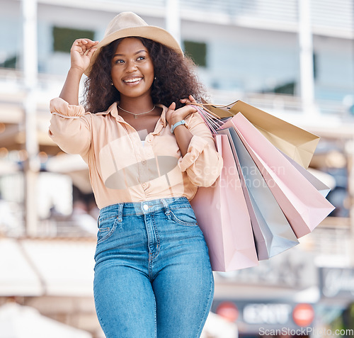Image of Black woman, retail shopping bag and city travel for discount sales, summer market and fashion promotion in San Francisco California. Happy, wealthy and freedom of fun young girl spending on vacation