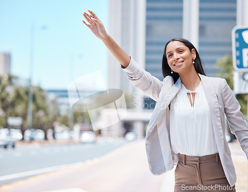 Image of City, business woman and calling for a taxi in the street to travel or commute to work in the morning. Happy, young and corporate employee doing a arm wave to get a cab or lift in a urban road.