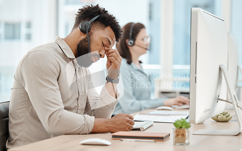 Image of Stress, headache and call center businessman on computer for customer service or consulting. Support agent, black man and telemarketing virtual advisor tired, frustrated or burnout at work office.