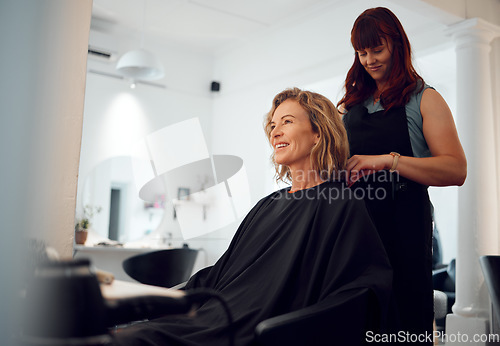 Image of Beauty, hairdresser and happy customer at a salon for grooming, fancy and beautiful makeover. Smile, wellness and professional stylist working on an elegant senior client or mature woman in Canada