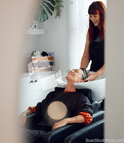 Image of Hairdresser, woman client and hair care to relax and smile after washing in the basin. Salon, beauty spa and professional stylist with a female customer for hairstyle change, pamper and good service