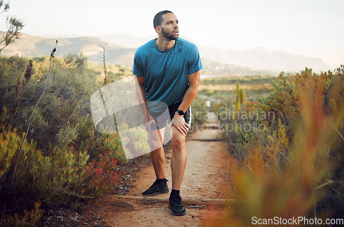 Image of Runner, fitness and tired man on nature park trail for training, exercise and cardio health for a summer marathon. Sport, male athlete and hiking workout while resting and taking break to breathe