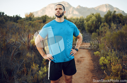 Image of Nature hiking, run and fitness workout of a man on a calm morning on a mountain park running trail. Health exercise, training and healthy person outdoor on walking or runner break with mountains view