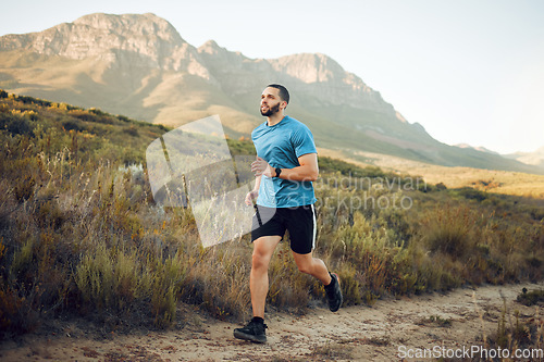 Image of Running, fitness and mountain nature park road run of a man runner outdoor for exercise. Training, sport and workout of a athlete with fast energy and stamina on a walking and hiking dirt trail