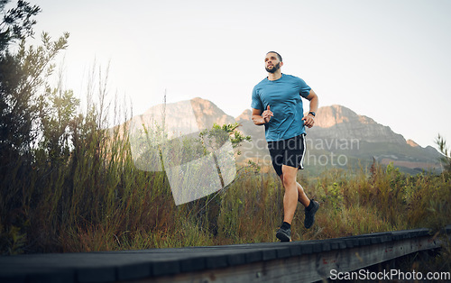 Image of Runner, fitness and man in nature running for outdoor workout, healthy energy and wellness goal with sky mock up background. Sports person with exercise training motivation jogging near the mountains