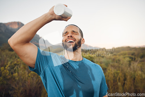 Image of Sports man splash water bottle on face in nature hiking, running or outdoor exercise in Spain mountain adventure. Runner spray drinking water on head for cardio training, cool body sweat and wellness