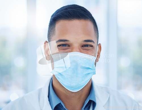 Image of Covid, face mask and portrait of a happy doctor in a hospital working, smiling and helping with healthcare expertise. Smile, compliance and medical worker with coronavirus safety protection in India