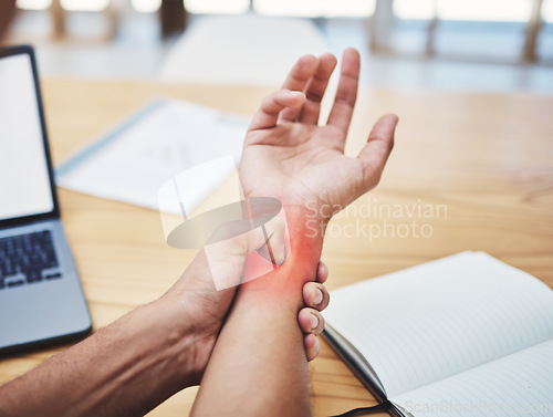Image of Businessman, wrist pain and injury at desk working, planning and writing in workplace with laptop. Painful muscle, male hand and overworked from typing with sore arm, notebook at work table.