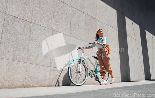 Image of Bike, urban and black woman cycling in the city of Norway for a sustainable lifestyle. Happy, young and smile African girl with a bicycle being eco friendly for her carbon footprint and clean energy