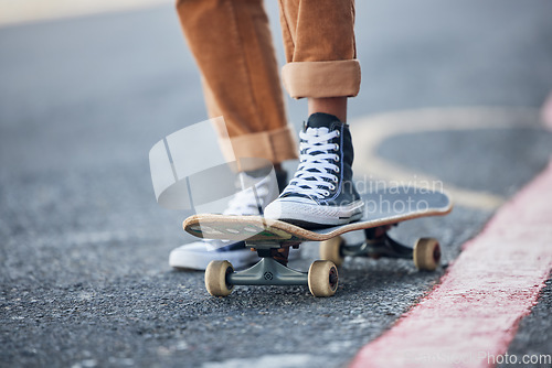 Image of Street, skateboard and riding shoes travel with balance for outdoor skating leisure practice. Stylish skateboarder man on concrete road for adventure trip with vintage, retro and shoe sneakers.