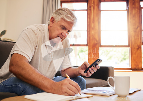 Image of Smartphone, budget planning and senior man in living room for retirement research, website investment information or asset management. Elderly person writing notes, using phone online finance banking