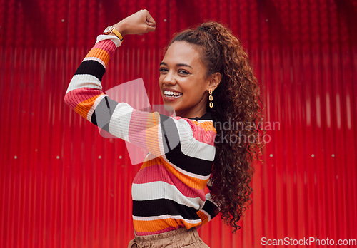 Image of Beauty, fashion and strong with a black woman flexing her bicep outdoor on a red background with a smile. Empowerment, proud and strength with an attractive young female showing her arm muscle