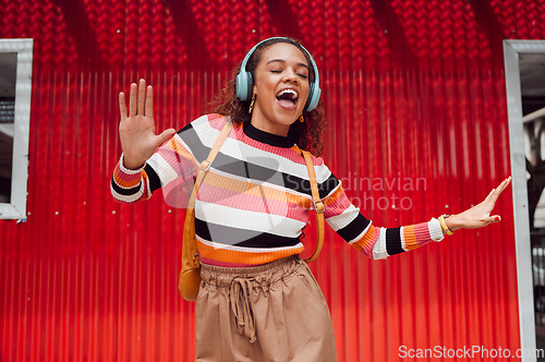 Image of Woman, dancing and headphones while listening to fun, energy and hip hop music outside in Sao Paulo. Music, dancer and a cool happy latino girl with trendy fashion outdoor feeling free in Brazil