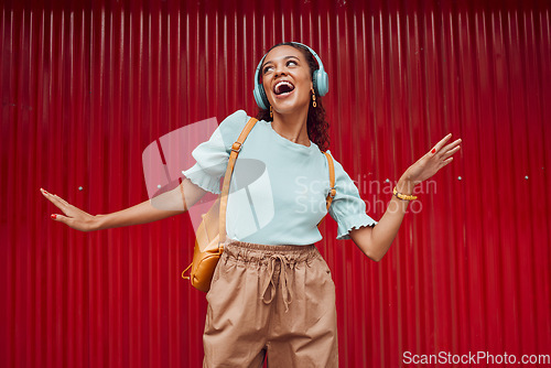 Image of Happy woman streaming music, singing and hip hop dance on stage with headphones. Young musical performer, fun and energy in trendy fashion .....broadway.solo act.dancing.listen to music.hip hop rmb