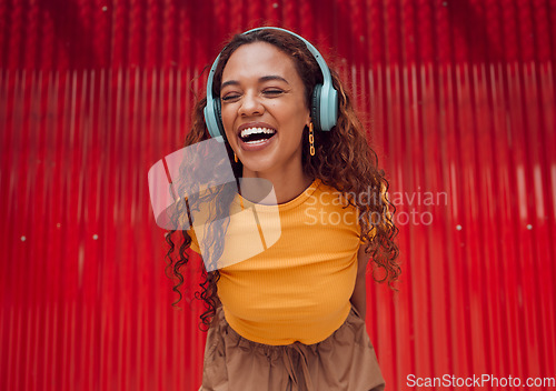 Image of Urban, joy and woman with headphone music enjoying happy rhythm with bluetooth connection. Smile of latino girl listening to feel good streaming audio while resting at wall for leisure break.