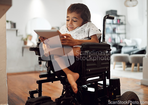 Image of Wheelchair, disability and child with tablet for learning, video or games in home. Cerebral palsy, boy and disabled use tech on internet, app or web for development of brain, mind and education