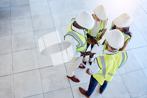 Image of Architecture, construction and engineering team planning a creative blueprint of a building on a tablet in an office. Teamwork, collaboration and group meeting of designers working on a floor plan