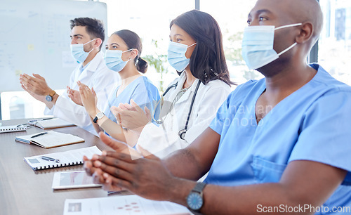 Image of Covid face mask, clapping and medical presentation for doctors, nurses or London hospital healthcare teamwork. Men, women and medicine team applause in seminar meeting for covid 19 compliance success