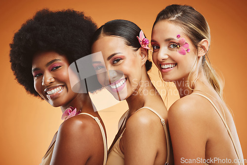 Image of Beauty, skincare and diversity with a model woman group in studio on an orange background for health or inclusion. Wellness, makeup and face with a portrait of female friends posing for empowerment