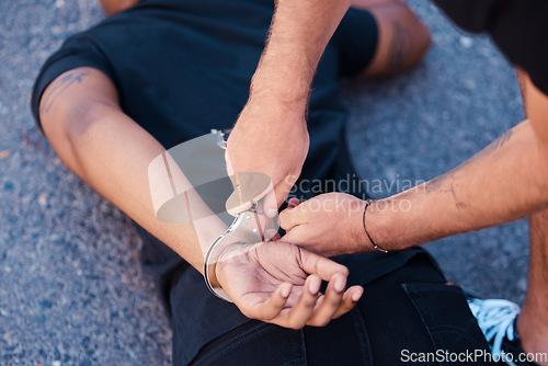 Image of Hands, handcuffs and man on floor with police agent, justice and human rights in Iran to stop protest. Crime, law and freedom in arrest in street, criminal or thief arrested in city by police officer