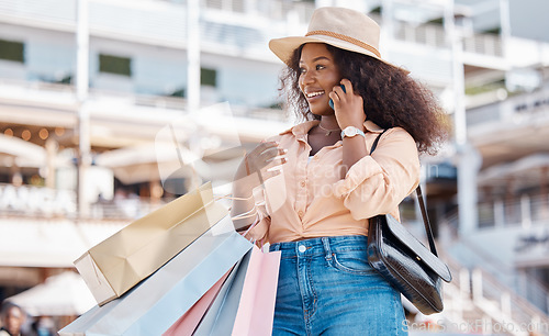 Image of Phone call, black woman and shopping bags of a person from Miami feeling happy about shop experience. Sale, store and retail purchase of a person in the city with mobile technology and smile outdoor