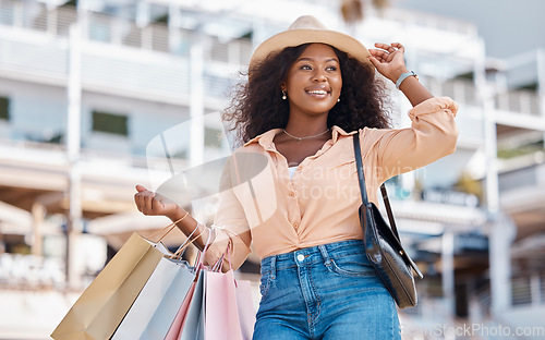Image of Shopping, fashion and city black woman with bag after retail therapy spree, sales discount or buying shop clothes. Boutique product, store shopping mall and happy customer with luxury designer gift