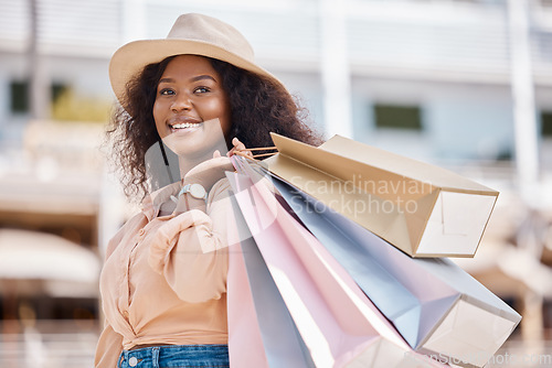 Image of Black woman, retail shopping bag and city customer buying sales, luxury fashion brands and summer market product choice from Brazil mall store. Style, happy and rich young consumer thinking in street