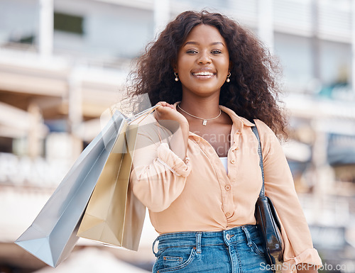 Image of Happy, city and black woman shopping for fashion, customer discount deals and clothes sales offer with freedom. Smile, portrait and excited shopper with urban retail clothing bags from boutique store