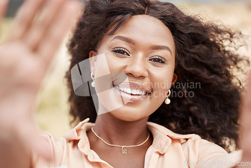 Image of Selfie, face and frame with a black woman taking a photograph outside during a bright summer day. Portrait, beauty and smile with an attractive African American female posing for a picture outdoor