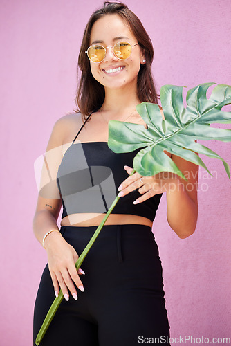 Image of Fashion, asian and portrait of woman with leaf of monstera plant in the city with cheerful smile. Young, happy and trendy girl enjoying summer leisure with funky, retro and vintage sunglasses.