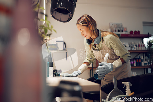 Image of Hair salon, cleaner and woman cleaning a workplace in Australia with equipment to disinfect. Housekeeper, maid or girl dusting table with hygiene, detergent and sanitizing products in beauty parlor