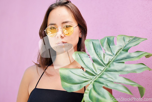 Image of Fashion sunglasses, asian and woman with leaf calm, relax and confident in her retro, vintage and yellow summer glasses. Beauty, skin and face portrait of chic gen z girl on Singapore travel vacation