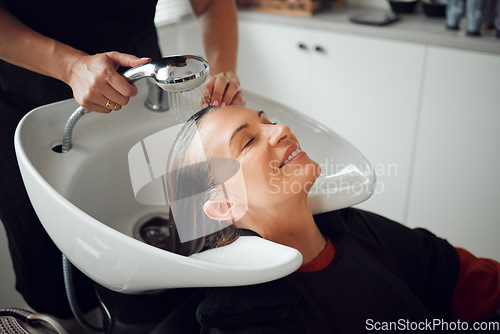 Image of Woman, salon and hair care in wash treatment for beauty, luxury and relax with smile indoors. Happy female enjoying calm relaxation smiling in happiness for clean, service and style by hairdresser