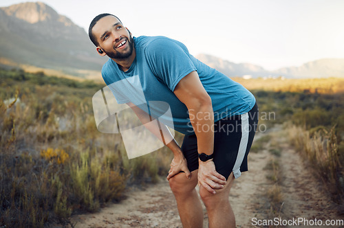 Image of Running, fitness and man thinking in nature while training in countryside for health. Athlete runner with smile, motivation and idea on a run on a dirt path or field for exercise, workout and cardio