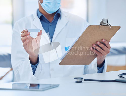 Image of Doctor hands check covid rapid antigen clipboard test results in healthcare hospital, medical risk and safety. Closeup corona virus surgeon, science worker and clinic research notes of pcr cassette