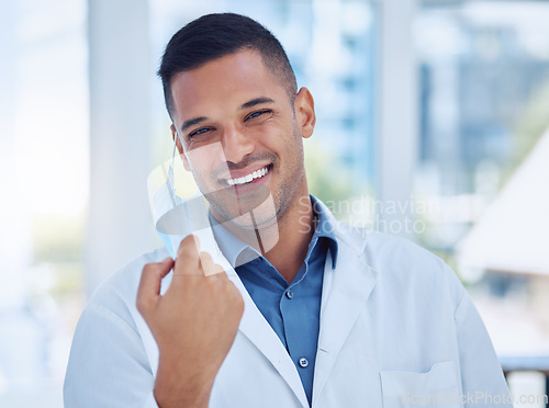 Image of Covid, healthcare and working doctor remove face mask at the end of the pandemic at a hospital. Portrait of a medical surgeon and worker happy with freedom and smile from covid 19 at a clinic