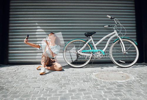 Image of Bicycle, street and woman taking a selfie in a city blowing a kiss in photo or pictures in summer outdoors. Freedom, bike and young girl creating phone content for social media followers in holidays