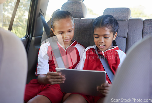 Image of Children, friends and tablet in car entertainment, online streaming or social media. Kids enjoying games or apps while relaxing in seat on touchscreen technology after sports training or soccer match