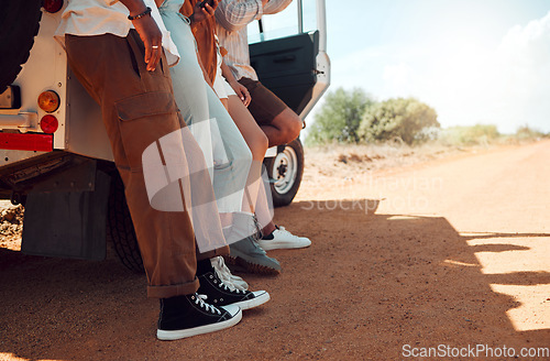 Image of Legs, travel and friends on a road trip with a car for holiday in Kenya together during summer. Feet of a group of people on vacation for adventure, freedom and peace with a car in the countryside