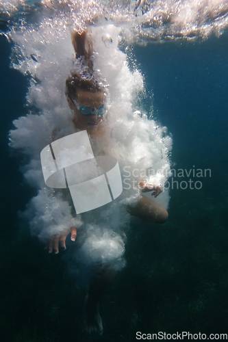 Image of Underwater swimmer surrounded by bubbles