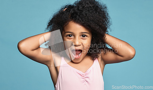 Image of Portrait, black girl child and excited being surprised, shocked and touch hair with blue studio background. Wow, African American female kid or natural hair or afro have fun, smile and happy for play