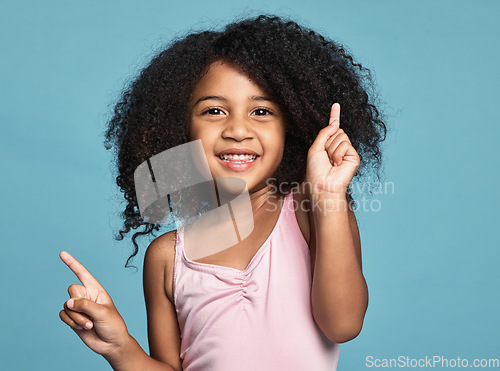 Image of .Children, dance and fun with a girl kid dancing in studio on a blue background for freedom or expression. Kids, happy and smile with a cute female child dancer feeling positive or carefree inside.